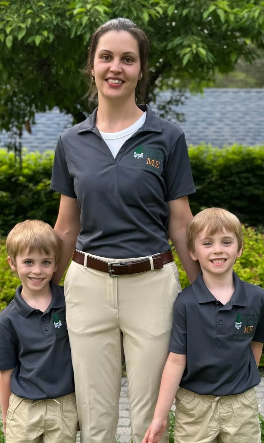 Becca standing with her husband and twin boys, wearing Event Rent ME shirts