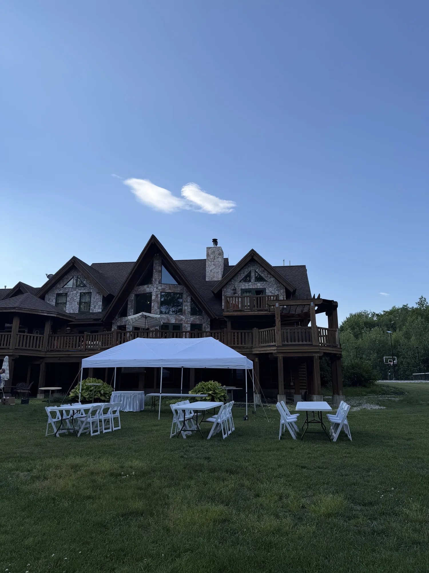 Pop-up canopy covering graduation party tables and chairs
